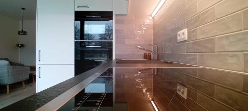 a kitchen with a sink and a counter top at Hof van Sassenbroek in Borgloon