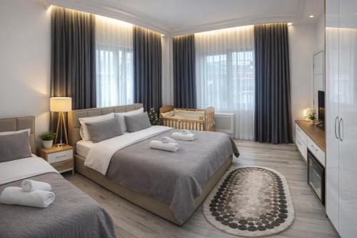 a bedroom with two beds with towels on them at Guest House Nuhellari - Family stay & Breakfast near Osumi Canyons in Çorovodë