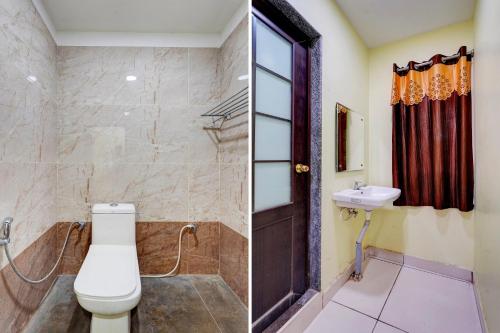 a bathroom with a toilet and a sink at Hotel Mini Escape Perungalathur in Chennai