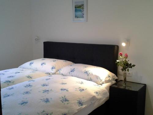 a bedroom with a bed with two pillows on it at Saghäusl in Mitterkleinarl