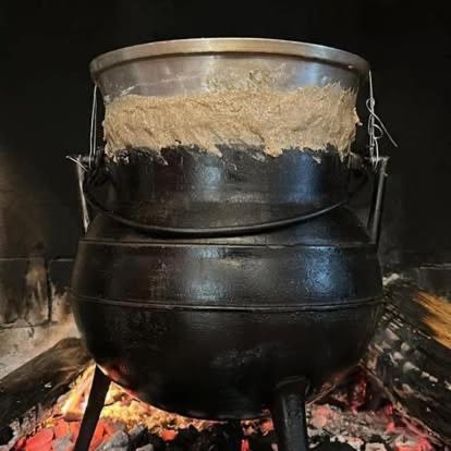a large pot sitting on top of a fire at Pensão S José-CUNHA'S in Vila Nova de Tazem