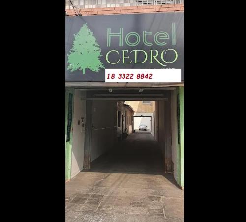 a building with a hotel octoria sign and a tunnel at Cedro Assis hotel in Assis