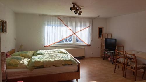 a bedroom with a bed and a window with a star on it at Retrowohnung Lindenhof Oberndorf in Oberndorf
