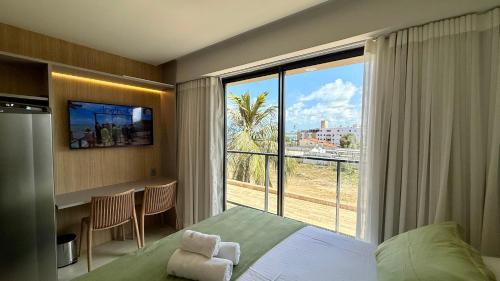 a hotel room with a bed and a large window at Flat Beira Mar 331 - 424 - 426 in João Pessoa
