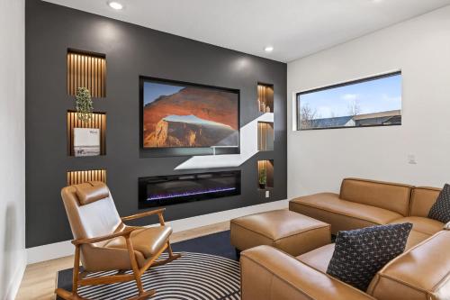 a living room with a couch and a fireplace at Modern Luxury at Copper View Moab in Moab