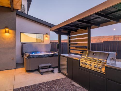 an outdoor kitchen with a grill and a grill at Modern Luxury at Copper View Moab in Moab