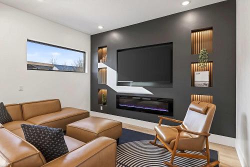 a living room with a couch and a tv at New Modern Luxury at Copper View Moab in Moab