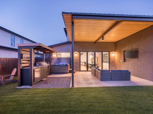 a backyard of a house with a kitchen and a patio at New Modern Luxury at Copper View Moab in Moab