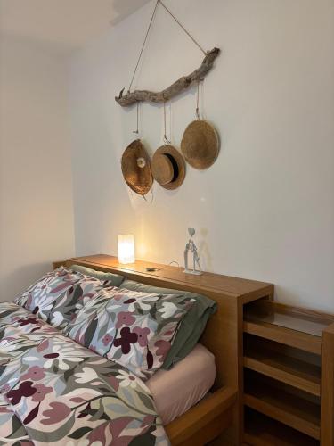a bedroom with a bed and a desk with hats on the wall at L'Intermezzo in Venzone