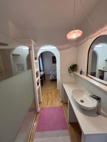 a bathroom with a sink and a mirror at L'Intermezzo in Venzone