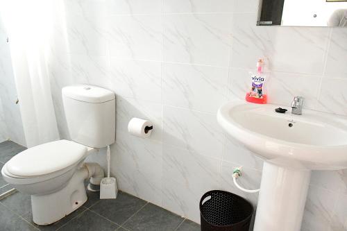 a bathroom with a toilet and a sink at Lion Hill Place in Nakuru