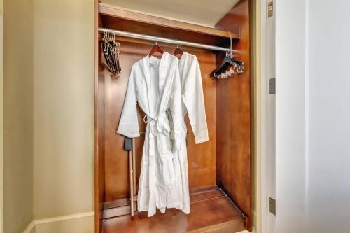 a white robe is hanging on a closet at 2B Beachfront condo! Pool! Games! 15 mins to PBI! in Riviera Beach