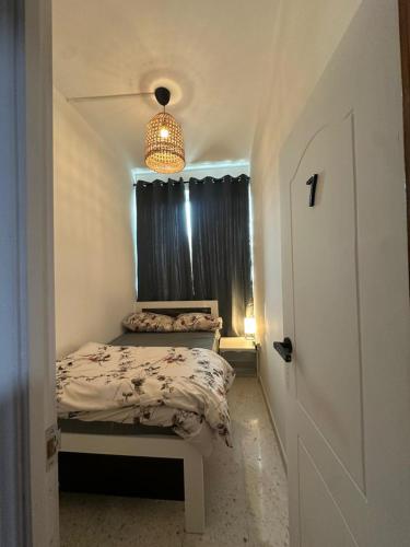 a small bedroom with a bed and a window at Private Room Late checkout 2pm in Abu Dhabi