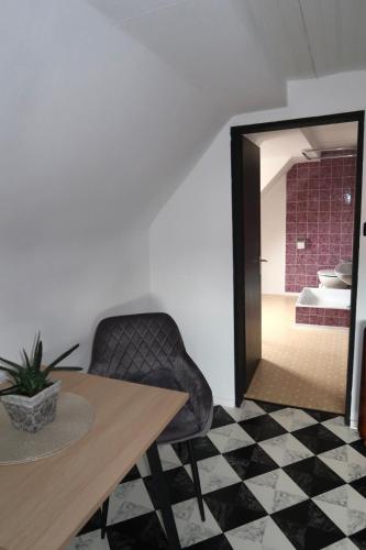 a dining room with a table and a chair and a mirror at Cozy room with bathroom in a private house in Bergrheinfeld