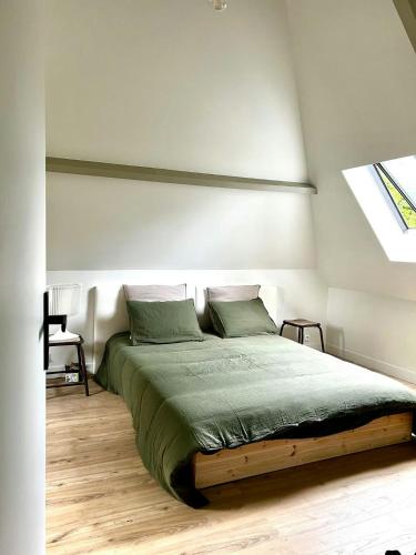 a bedroom with a bed in a room with a window at Charming House In Lyons-La-Forêt in Lyons-la-Forêt