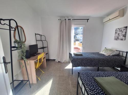 a room with two beds and a window at Villa Nevada - Espacioso Chalet con Piscina Privada y Salita de Cine in Port de Pollensa
