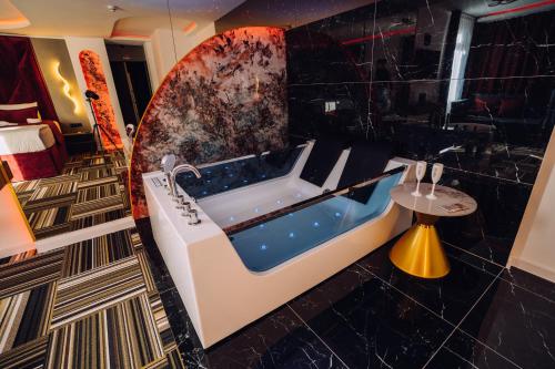 a bathroom with a bath tub in a room at PARK INN, Bugojno in Bugojno