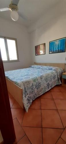 ein Schlafzimmer mit einem Bett in einem Zimmer mit zwei Fenstern in der Unterkunft Attico 5 in Ustica
