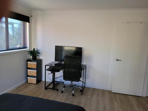 a bedroom with a desk and a chair in a room at Easy homestay for solo traveller in Rokeby