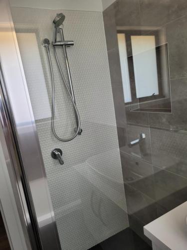 a shower with a glass door in a bathroom at Easy homestay for solo traveller in Rokeby