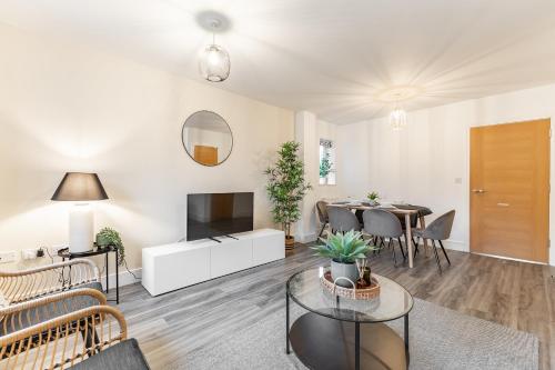 a living room with a couch and a table at Heathrow House with Parking - Sleeps 5 near M25, Virginia Water, Thorpe Park & Legoland, Mid To Long Term Bookings Welcome in Stanwell
