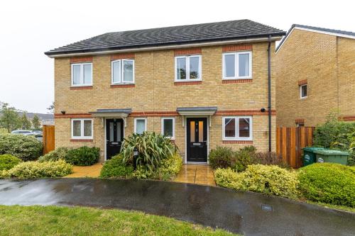 a brick house with a driveway in front of it at Heathrow House with Parking - Sleeps 5 near M25, Virginia Water, Thorpe Park & Legoland, Mid To Long Term Bookings Welcome in Stanwell