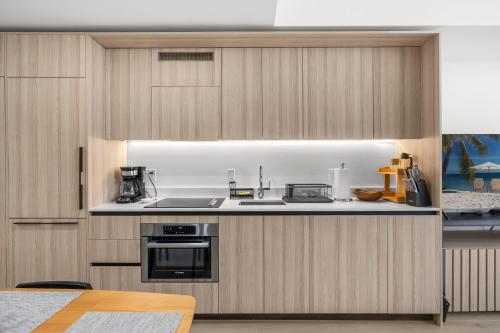 a kitchen with a sink and a stove top oven at Downtown Miami - Rooftop Pool & Gym in Miami