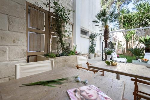 a patio with a table with a picture of a woman on it at Palazzo Dei Dondoli in Lecce