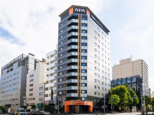 a building with an acm sign on the top of it at APA Hotel Higashi Shinjuku Kabukicho Higashi in Tokyo