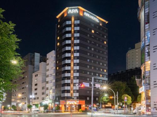 a building with an mgm hotel sign on top at night at APA Hotel Higashi Shinjuku Kabukicho Higashi in Tokyo