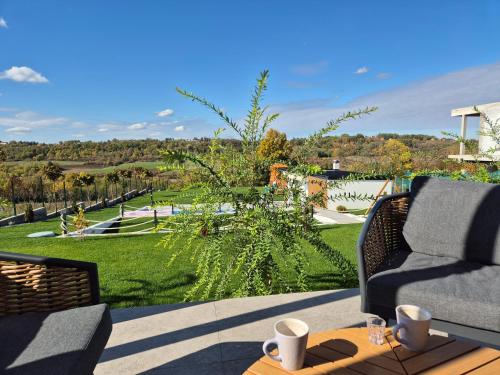 a patio with a couch and a table at Casa Toleni in Ba°evac
