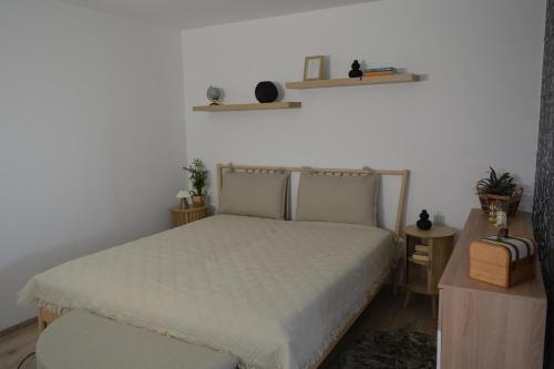 a bedroom with a bed and shelves on the wall at Wolkenfrei am Sonnenhang - Moderne Wohlfühl-Oase mit sonniger Süd-Terrasse in Lebach