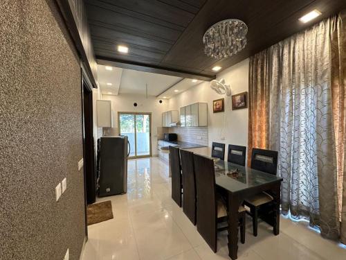 a kitchen with a table and a dining room at Joyous stay in Jaipur