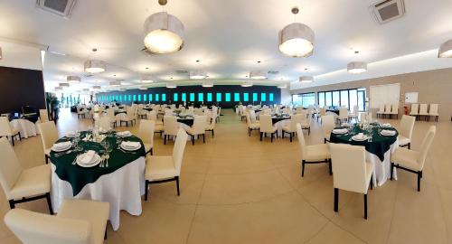 a large banquet hall with tables and white chairs at Quinta do Mateus in Aveiro