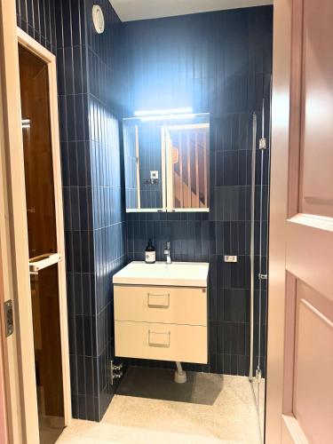 a bathroom with a sink and a mirror at Alpine Townhouse - Åre Valley Lodges in Åre
