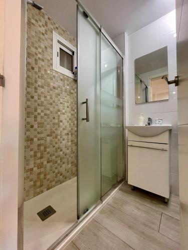 a bathroom with a shower and a sink at Jupiter Sea View in Benalmádena