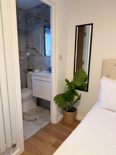 a bathroom with a bed and a sink and a tub at Studio Flat in New Barnet in New Barnet