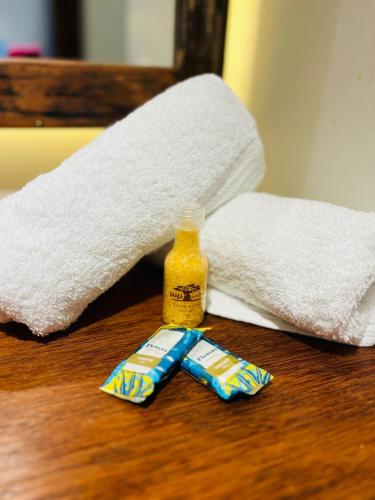 a bottle of toilet paper and a toothbrush on a table at Studio com Jacuzzi na Natureza Casal Baoba Suite in Bombinhas