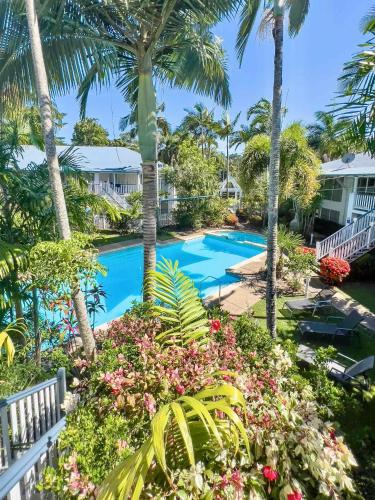 a view of the pool from the balcony of a resort at Island Glow in Airlie Beach