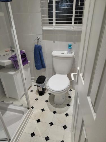 a bathroom with a toilet and a black and white floor at ElE G Holiday let's Bridlington in Bridlington