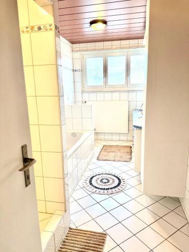 a bathroom with a shower and a tub and a sink at Private 5 bedroom for large Groups in Hunzenschwil