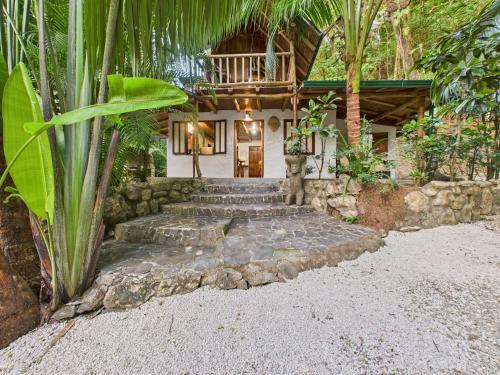 a house with a bunch of stairs in front of it at Pachamama Bungalows & Surfcamp - Santa Teresa in Carmen