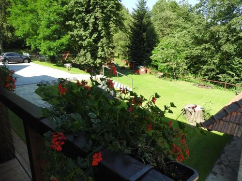 a garden with flowers on a retaining wall at Hotel a restaurace U Vychopňů in Vsetín