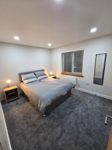 a bedroom with a large bed and a window at 25 Colliers Road,Stirling in Plean Station