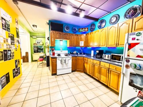 a kitchen with wooden cabinets and a white refrigerator at Hostel Detroit in Detroit