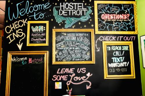 a wall with many chalk signs on it at Hostel Detroit in Detroit
