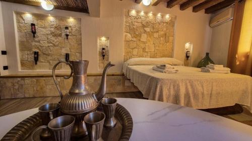 a hotel room with two beds and a tea kettle on a table at Borgo Antico - Barrique Studio in Lotzorai