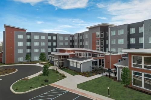 an rendering of an apartment building with a courtyard at Residence Inn by Marriott Newark, DE in Newark