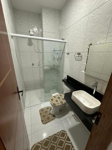 a bathroom with a shower and a toilet and a sink at Flat JK em Dona Inês-pb in Dona Inês
