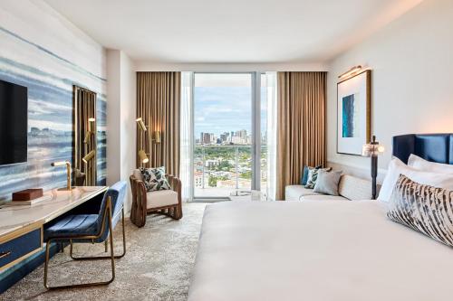 a hotel room with a large bed and a desk at Omni Fort Lauderdale Hotel in Fort Lauderdale